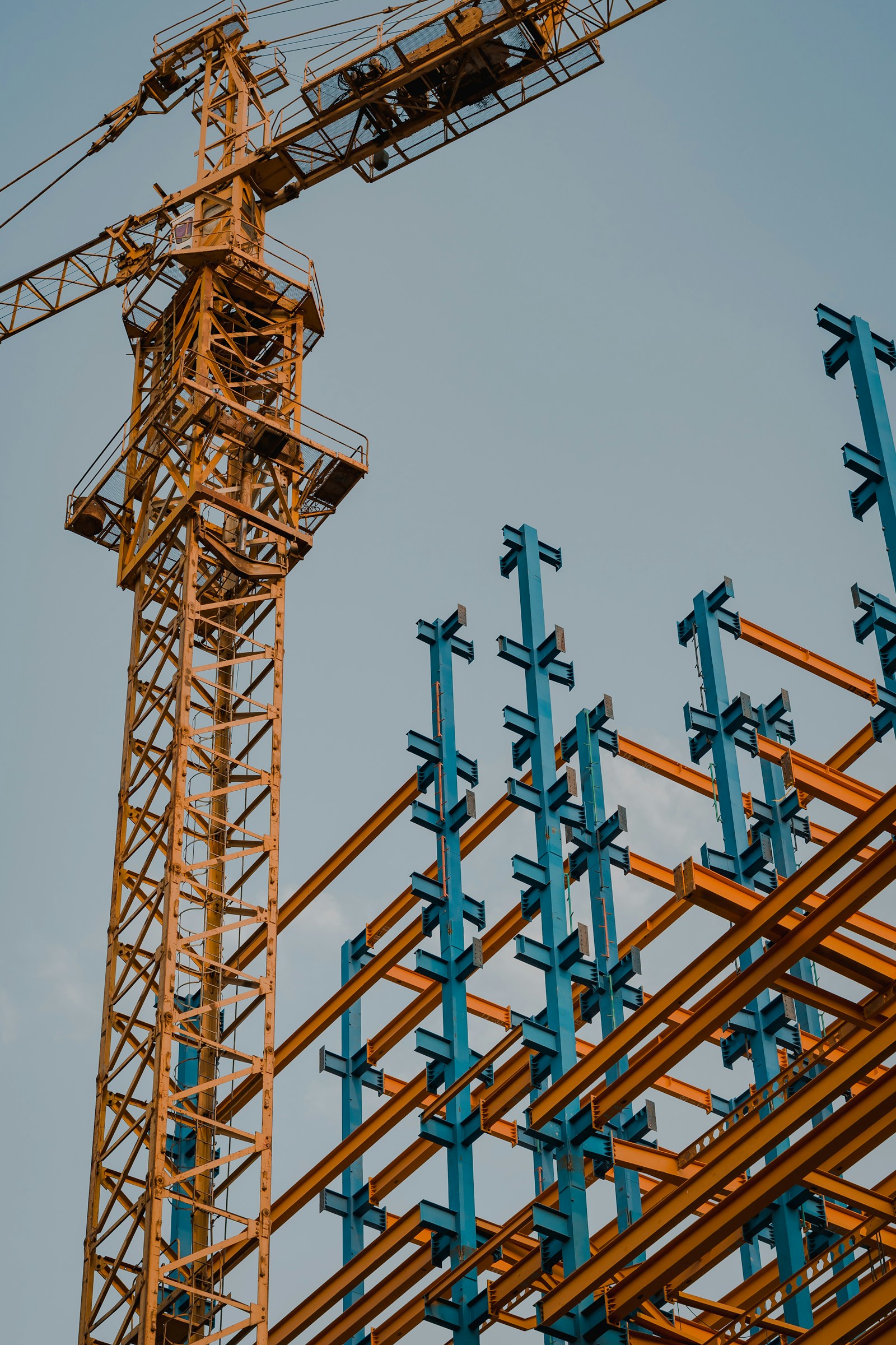 Yellow and blue tower crane at a high-rise construction site in the Dominican Republic